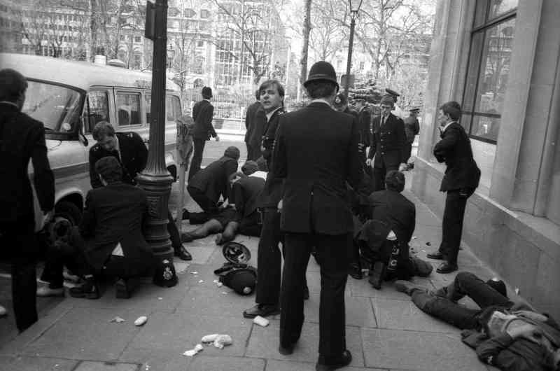 Police officers surround Yvonne Fletcher after the fatal shooting in St James’s Square