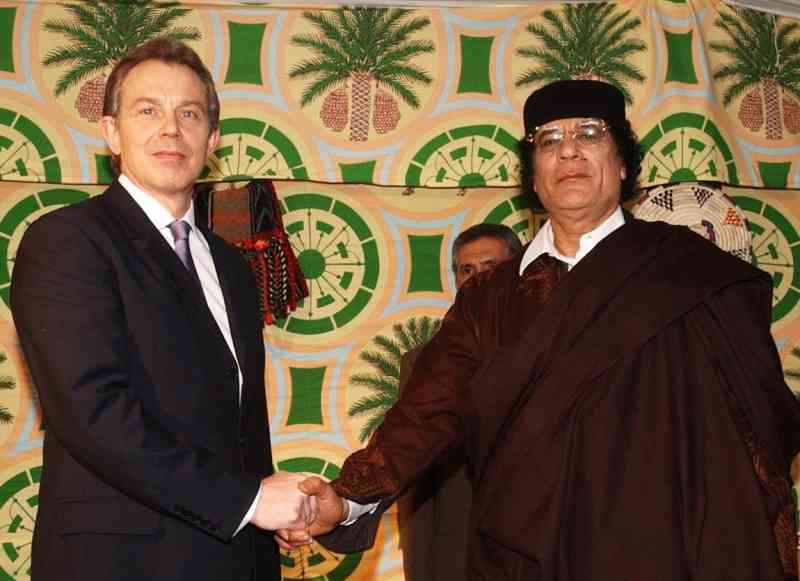 Tony Blair greets Colonel Gaddafi before talks in Tripoli in March 2004